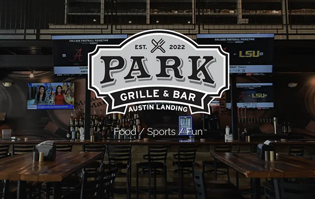 Indoor sports bar and grill with a large PARK Grille & Bar sign above the dining area.