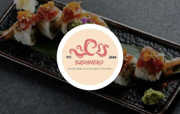 Plate of assorted sushi rolls with wasabi and pickled ginger on a dark rectangular tray, with a circular logo overlay in the center.