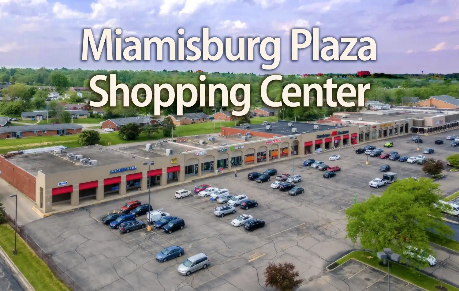Aerial view of Miamisburg Plaza Shopping Center with a long row of storefronts and a parking lot.