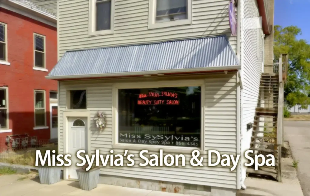 Miss Sylvia's Salon & Day Spa storefront on a beige, two-story building with a metal awning.