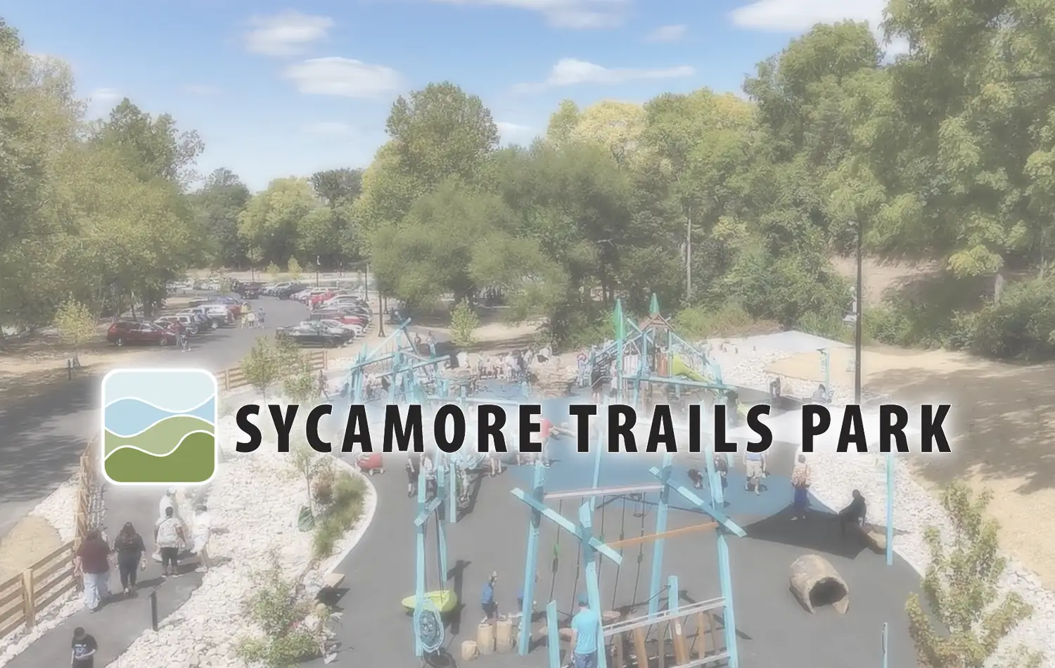 Aerial view of Sycamore Trails Park with a blue playground structure, paths, and trees.